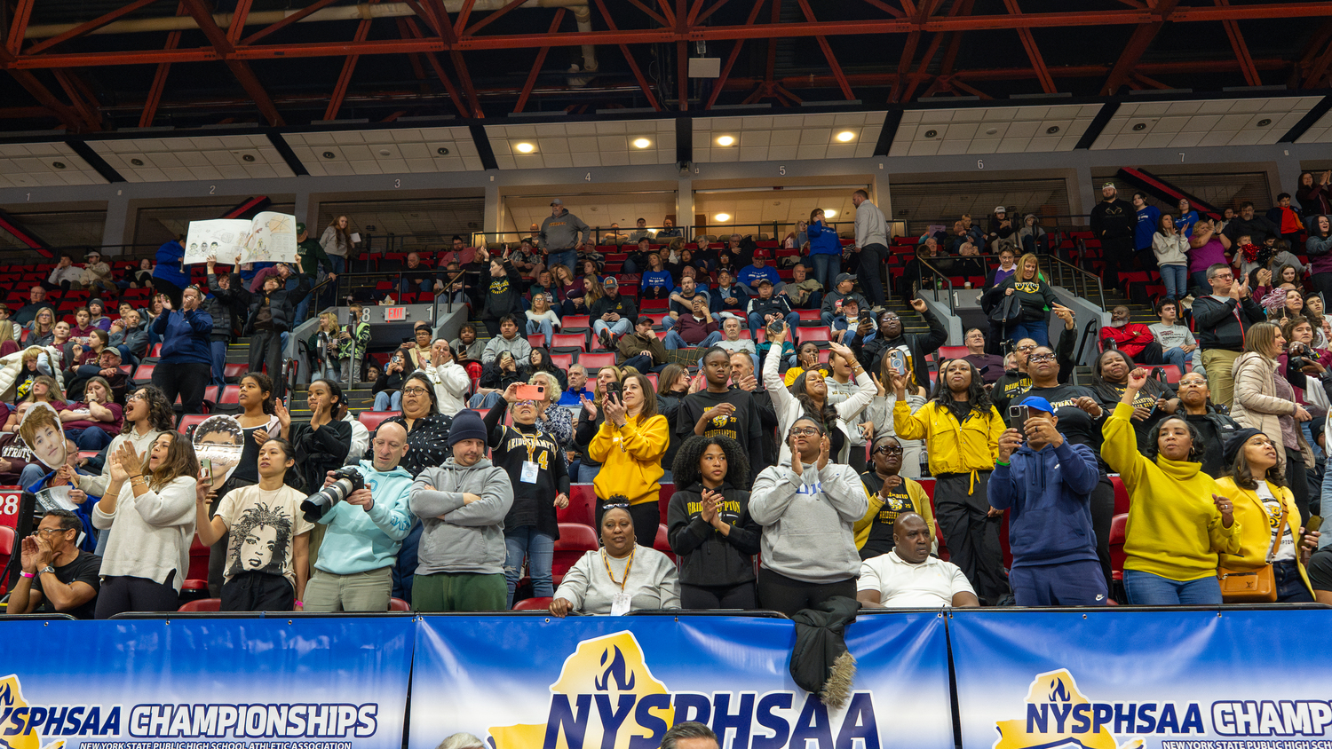 The Bridgehampton crowd cheers on its Killer Bees at Visions Veterans Memorial Arena in Binghamton on Friday.   RON ESPOSITO