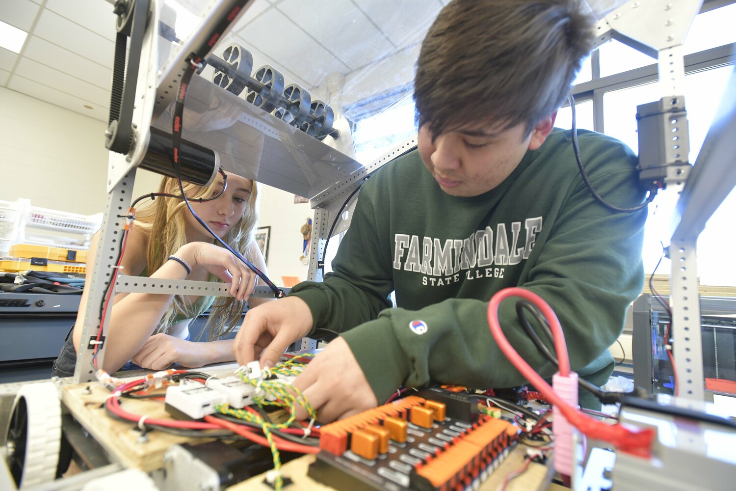 Aristides Gonzalez and Aubrey MacDonald of the Marinators FRC Team 9646 prepare for the competition.  DANA SHAW