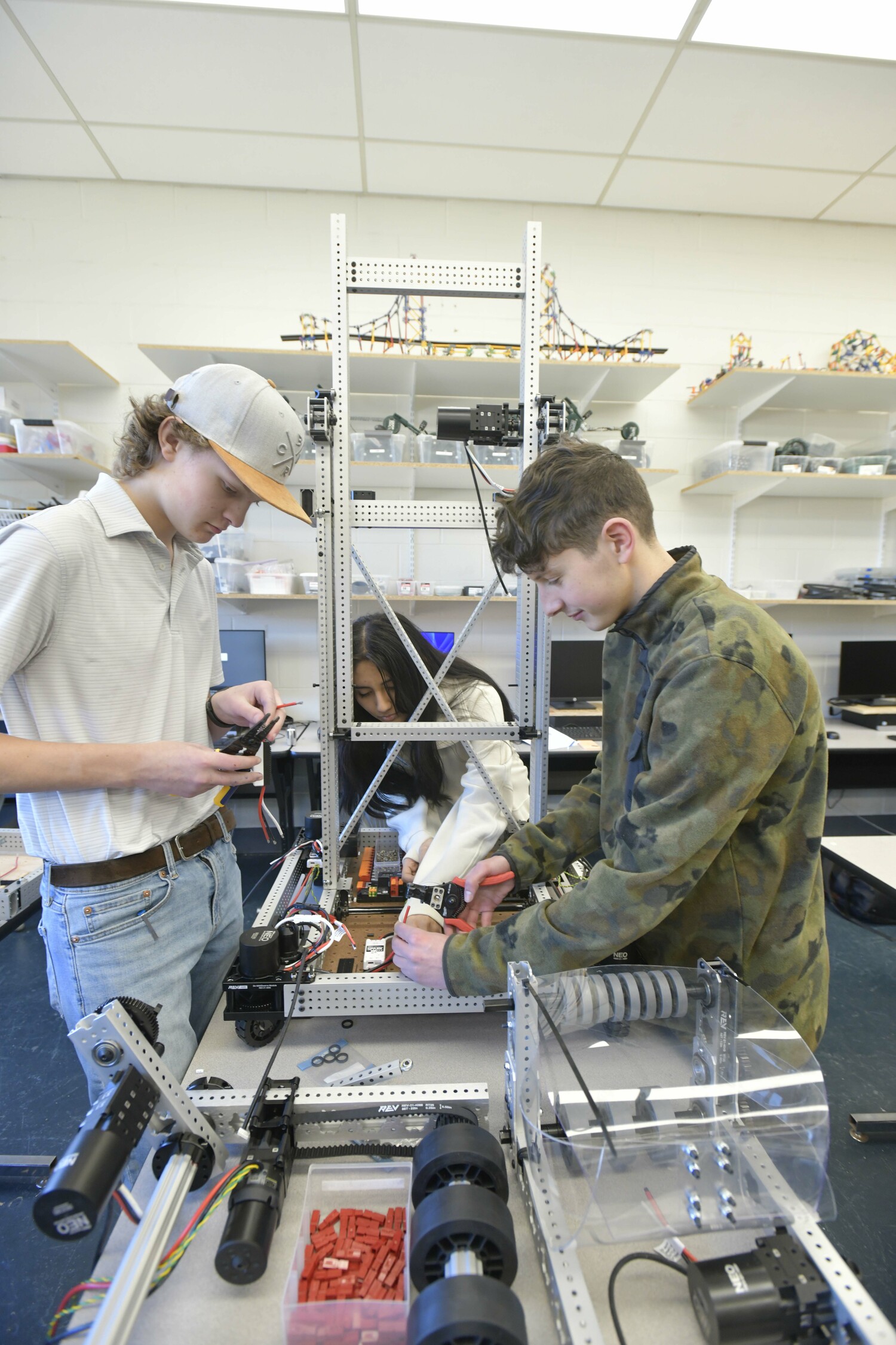 Isaiah Warden, Sara Barros and Colin Heaney work on a bot.  DANA SHAW