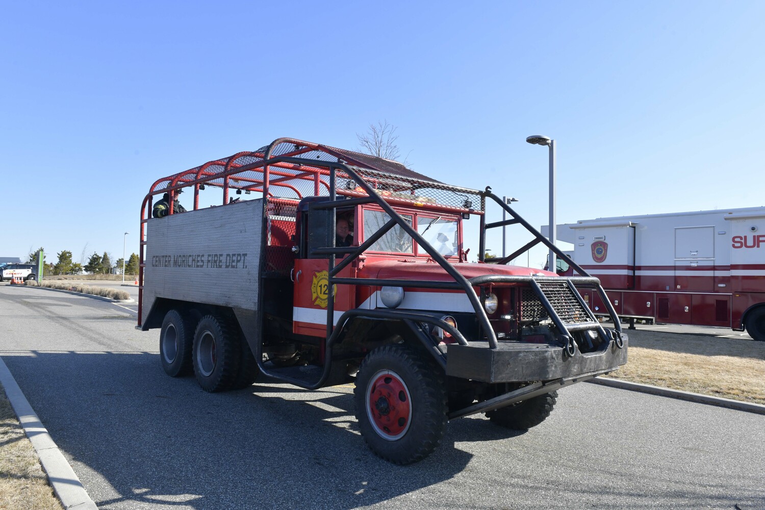 Fire departments patrol Old Riverhead Road in Westhampton on Sunday, looking for 