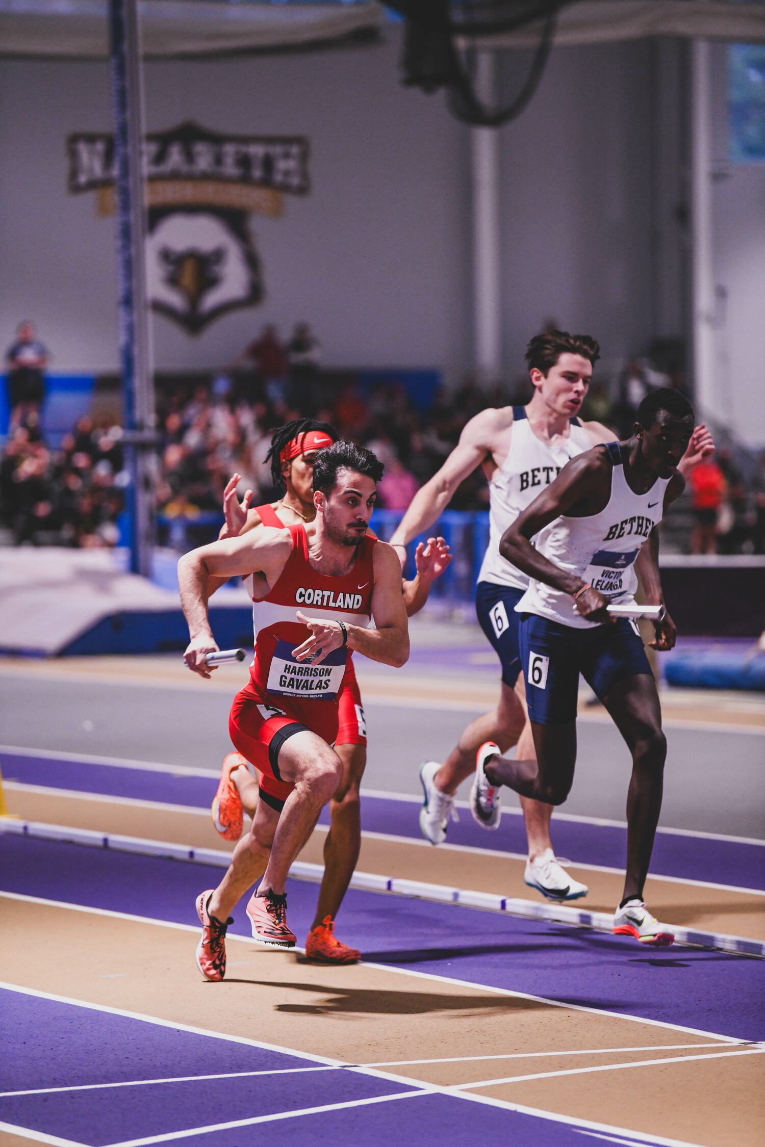 Harrison Gavalas takes the baton from Zion Cheatham in the 4x400-meter relay.   EDL PHOTOGRAPHY/ERIN LOCASCIO