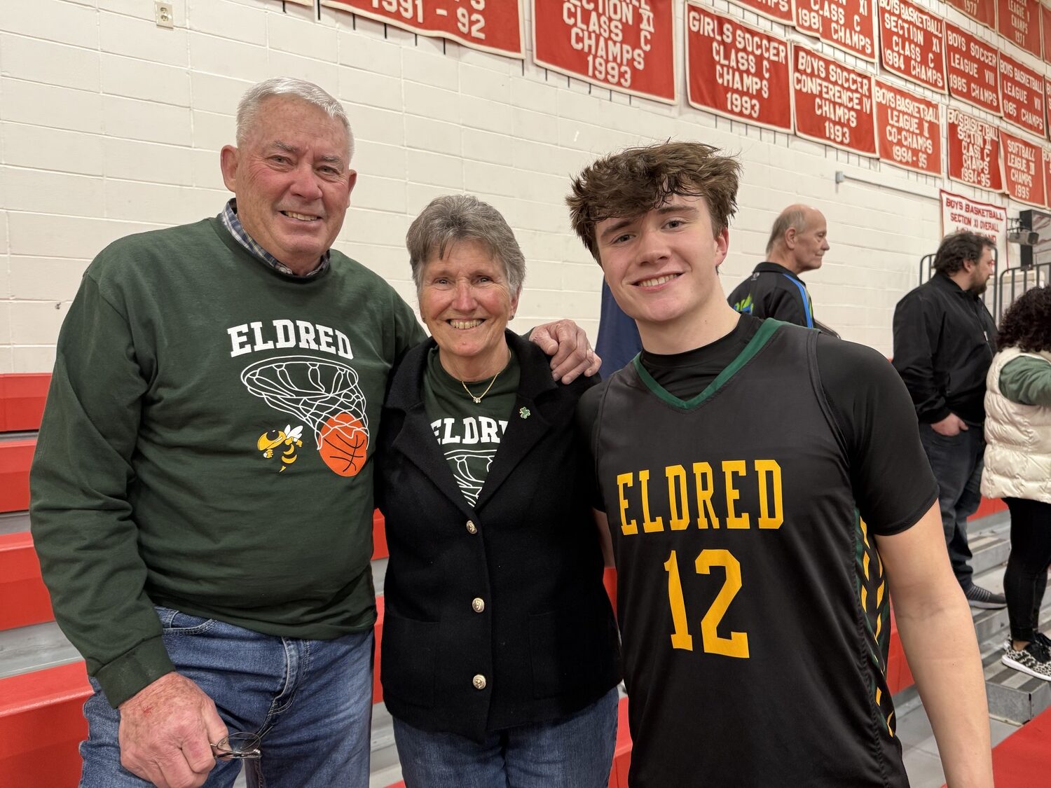 Ed and Bethany Deyermond with their grandson, James Deyermond, at Center Moriches High School after the Eldred boys basketball team lost to its belief to upset Bridgehampton in the Class D state regional final on Saturday. The Killer Bees, who play just down the road from the Deyermond’s Sag Harbor home, advanced in the state tournament while James and his Yellowjacket teammates had their season come to an end. GAVIN MENU