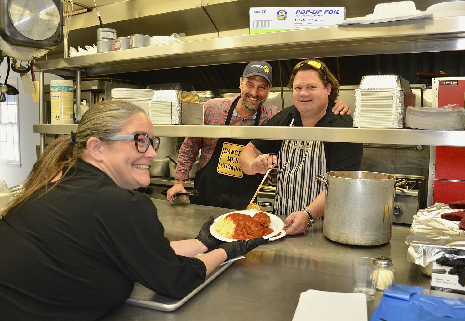 Rotary members Lara Siska, Jason LaGarenne and Joe Hren in the kitchen at the East Hampton Rotary Club's spaghetti meatball dinner on Sunday at the American legion Hall in Amagansett.   KYRIL BROMLEY