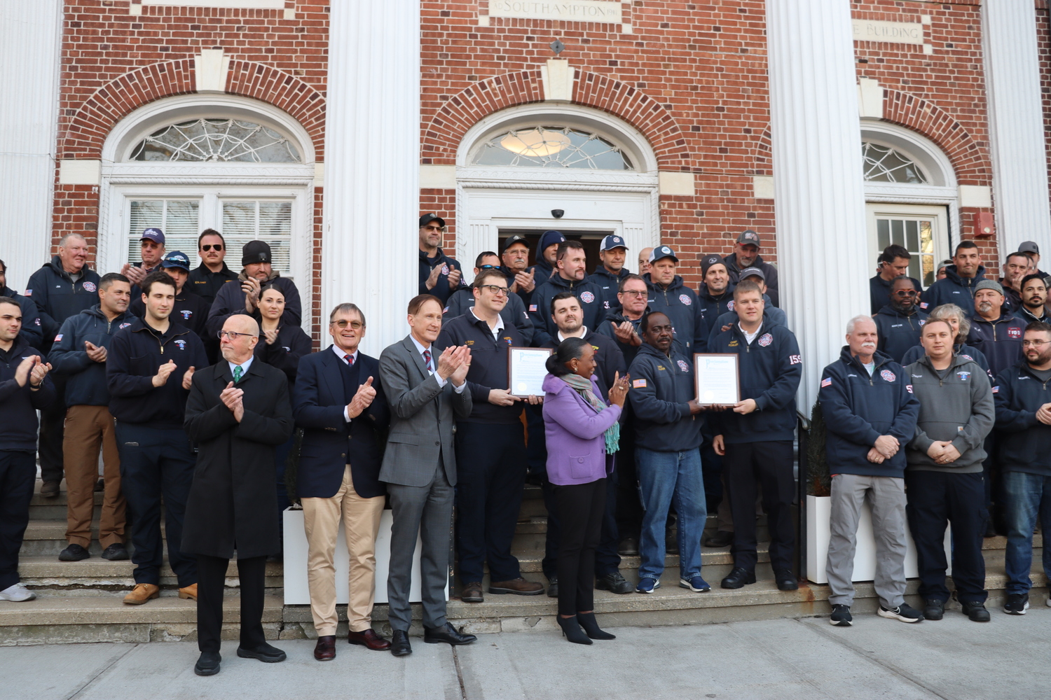 The Southampton Village Board presented members of the Southampton Fire Department with a proclamation on Thursday evening on the steps of village hall, honoring them for their efforts in fighting the Westhampton wildfires. Each member of the department was treated to a free beer at Fellingham's. CAILIN RILEY PHOTOS