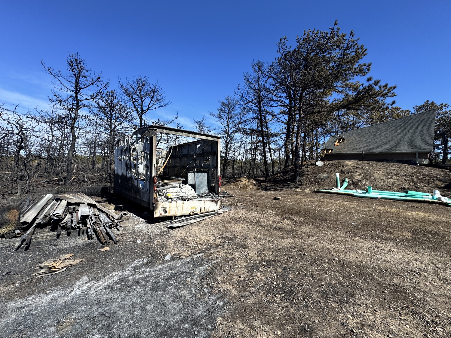 The fire destroyed a storage trailer and badly damaged a barn at AutoGate Systems on Old Riverhead Road in Westhampton. MICHAEL WRIGHT