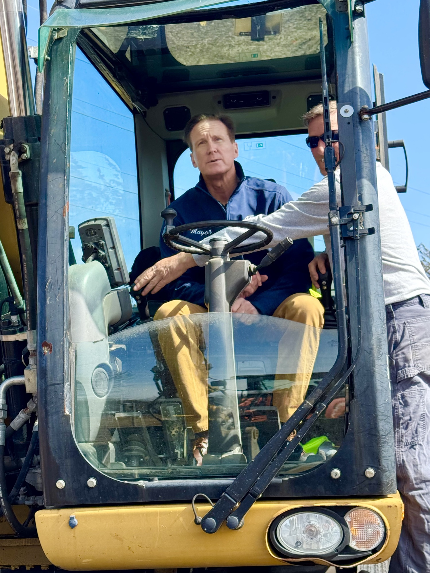 Southampton Village Mayor Bill Manger gets some hands-on assistance from Steve Elliston of the Highway Department. NANCY KANE