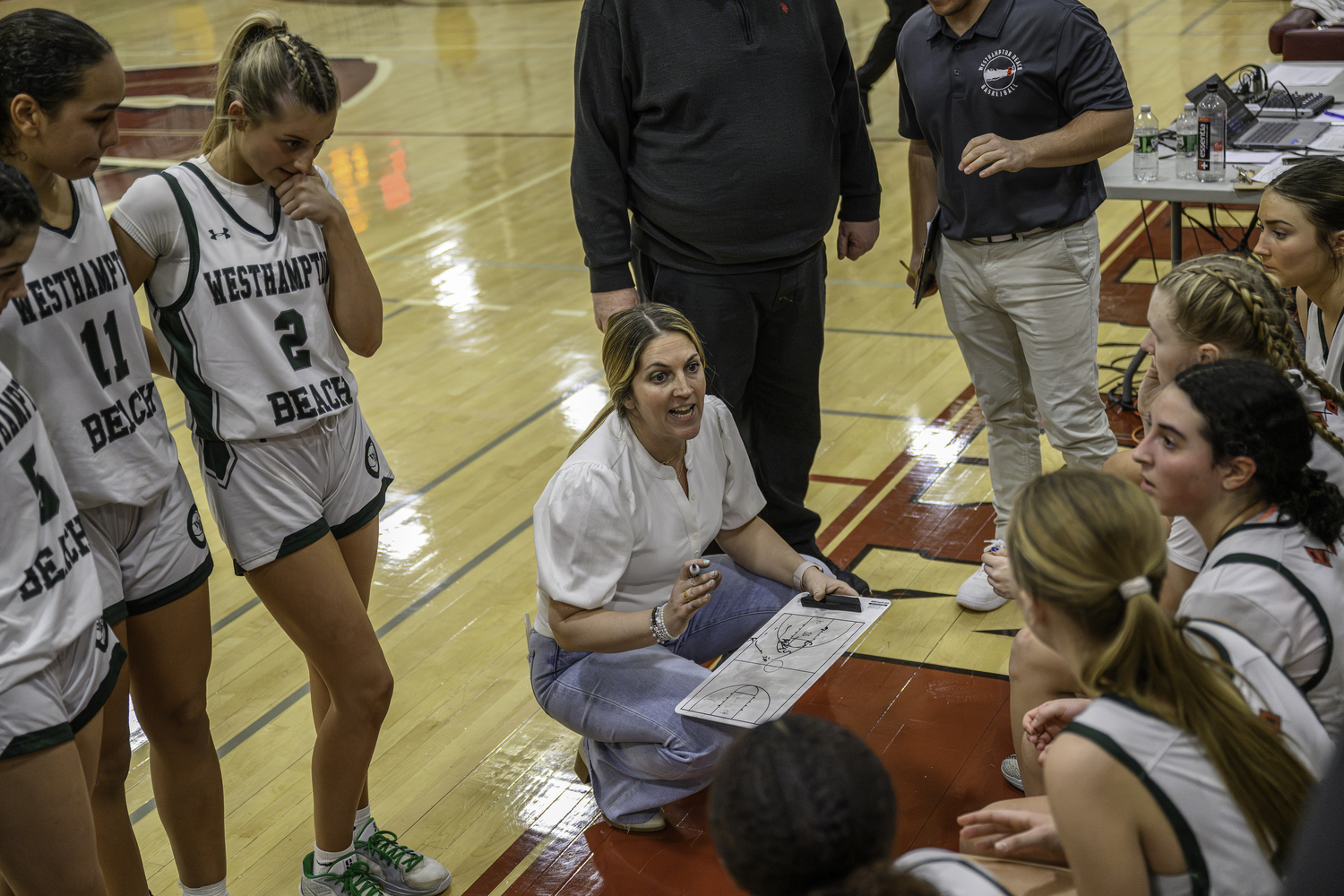 Head coach Katie Peters strategizes with her players during the final timeout. MARIANNE BARNETT