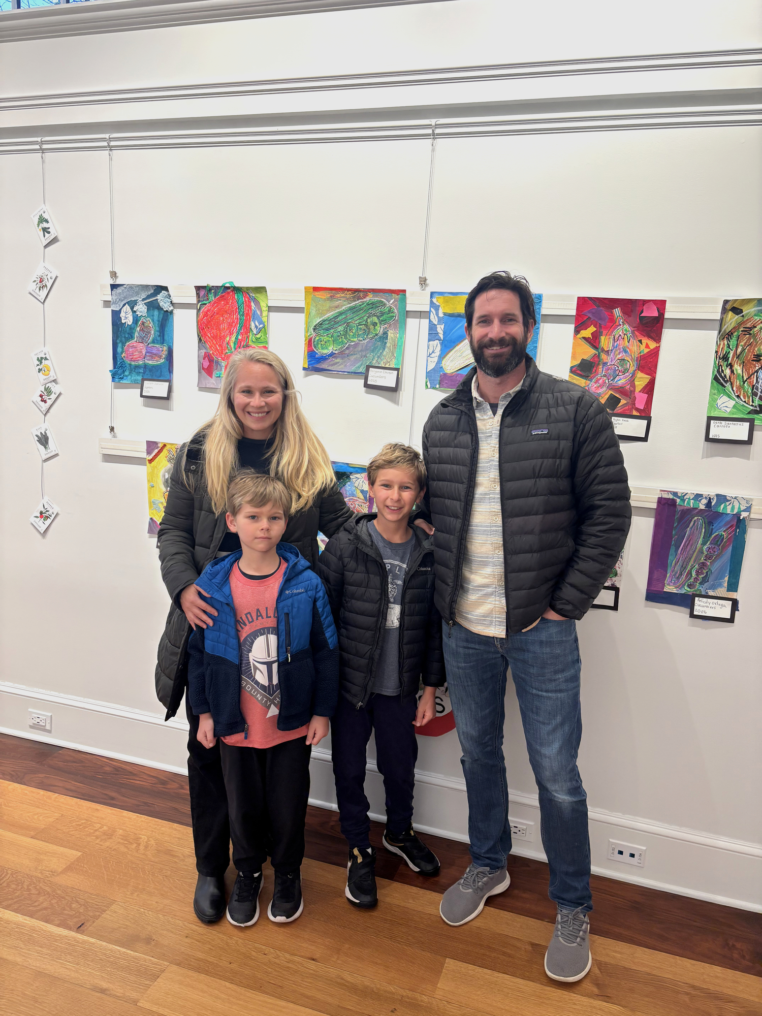 The Quogue Library hosted a reception for students, and their families, for the East Quogue School's Kid Art Inspired by Vegetables & Plants exhibit, which is on display through April 3. The works were inspired by the artwork of artist Lina Puerta, whose work focuses on indigenous farming practices and the differences between man-made food and food grown from the Earth. From left, Catie Dawson, Finn Dawson, Ben Dawson (student artist), Luke Dawson, and Ben's work titled 