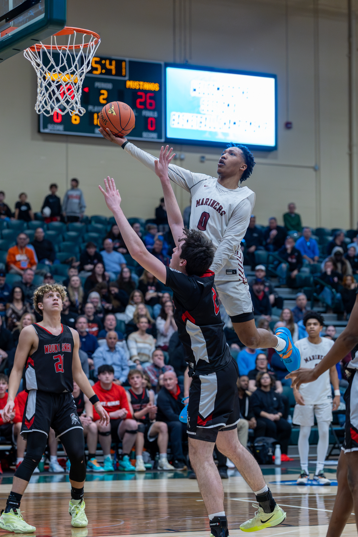 Naevon Williams tries to score over Mount Sinai's Brian Vales.   RON ESPOSITO