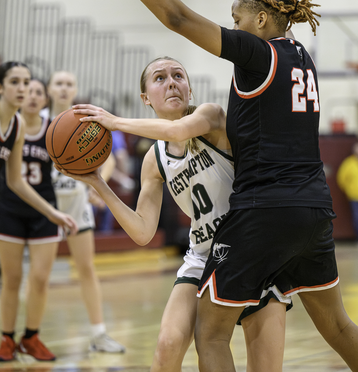 Westhampton Beach senior forward Shannon Sweet is guarded by Hills East senior Alex Brown under the basket. MARIANNE BARNETT