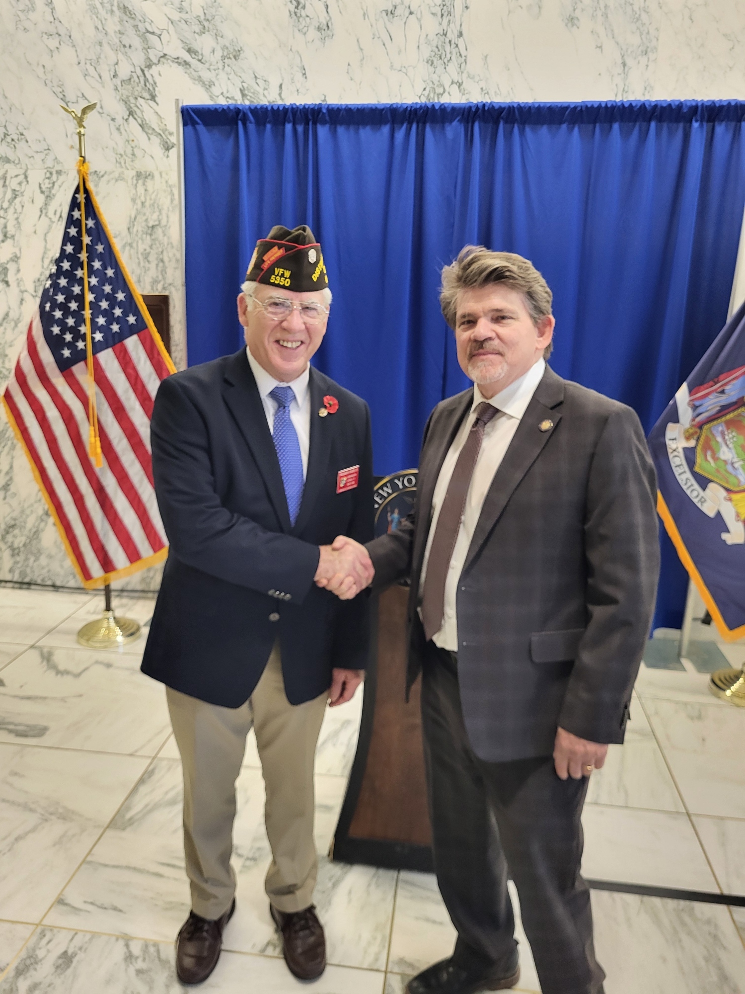 Leadership from the Veterans of Foreign Wars recently traveled to Albany and have since announced that Senator Anthony Palumbo and Assemblyman Tommy John Schiavoni have sponsored a bill that provides both physical and mental assistance to disabled Veterans in New York State by providing free access to SUNY and CUNY health facilities at these campuses.  VFW District 11 Commander William Hughes and Assemblyman Tommy John Schiavoni in Albany. COURTESY WILLIAM HUGHES