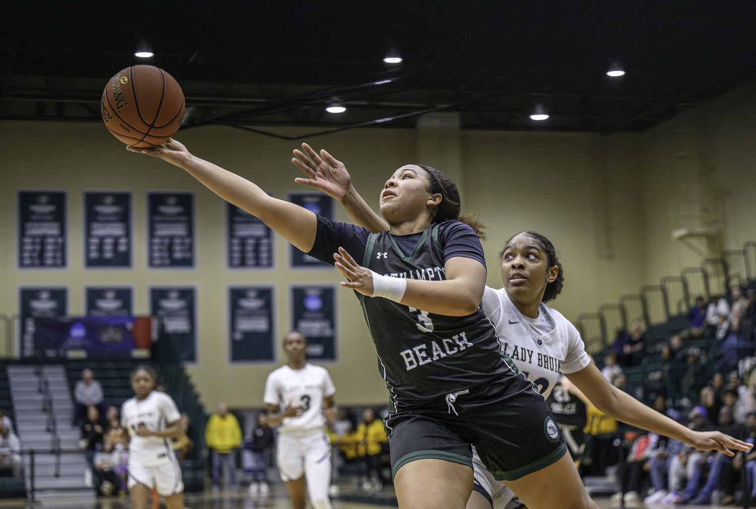 Junior point guard Sandra Clarke reaches toward the hoop. MARIANNE BARNETT