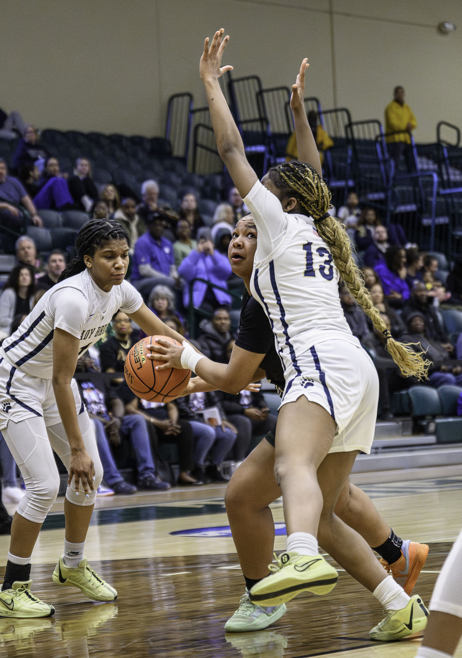 Junior point guard Sandra Clarke is heavily guarded as she looks to the basket. MARIANNE BARNETT