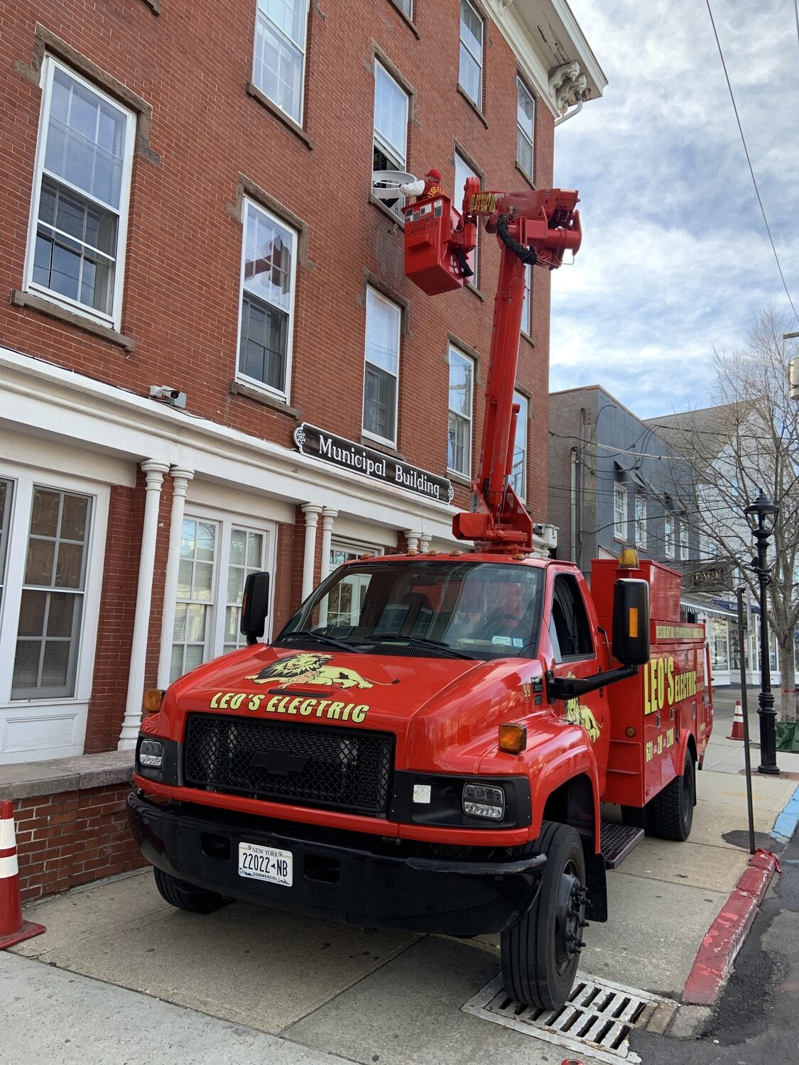 A crew from Leo's Electric installed a new clock donated by the Sag Harbor Partnership on the Sag Harbor Municipal Building Monday. STEPHEN J. KOTZ