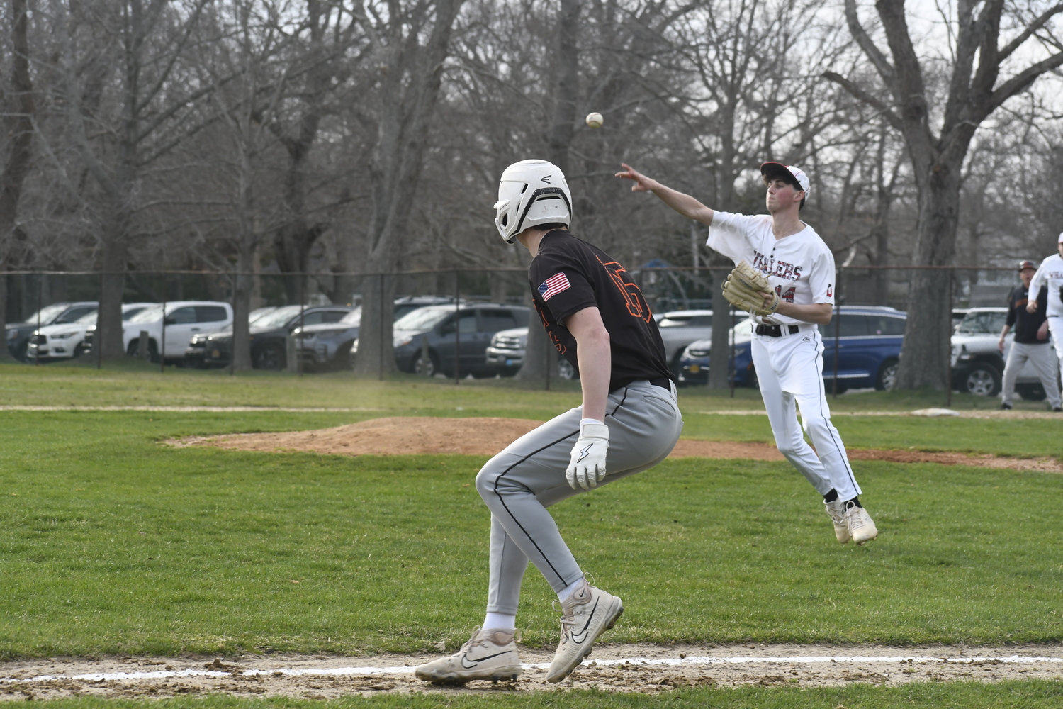 Braeden Mott tries to cut down a Babylon runner between third base and home plate.   DREW BUDD