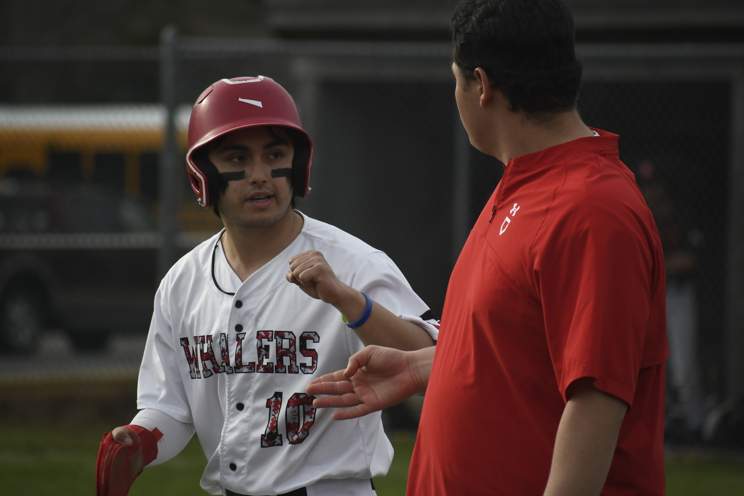 Max Krotman gives a pound to coach Tyler Laborne who was filling in for ill head coach Bob Manning on Friday.   DREW BUDD