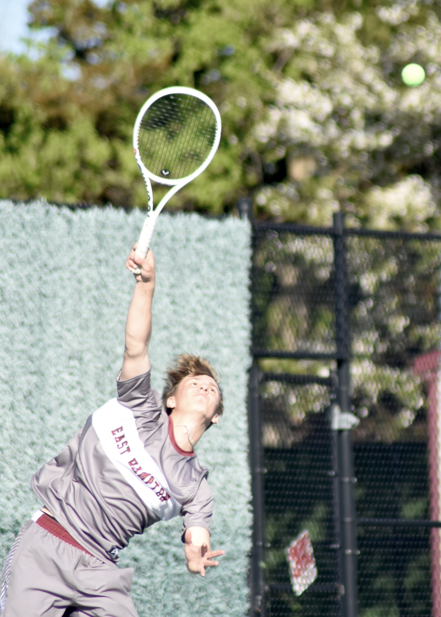 Senior C.J. Baumrind serves. DESIRÉE KEEGAN