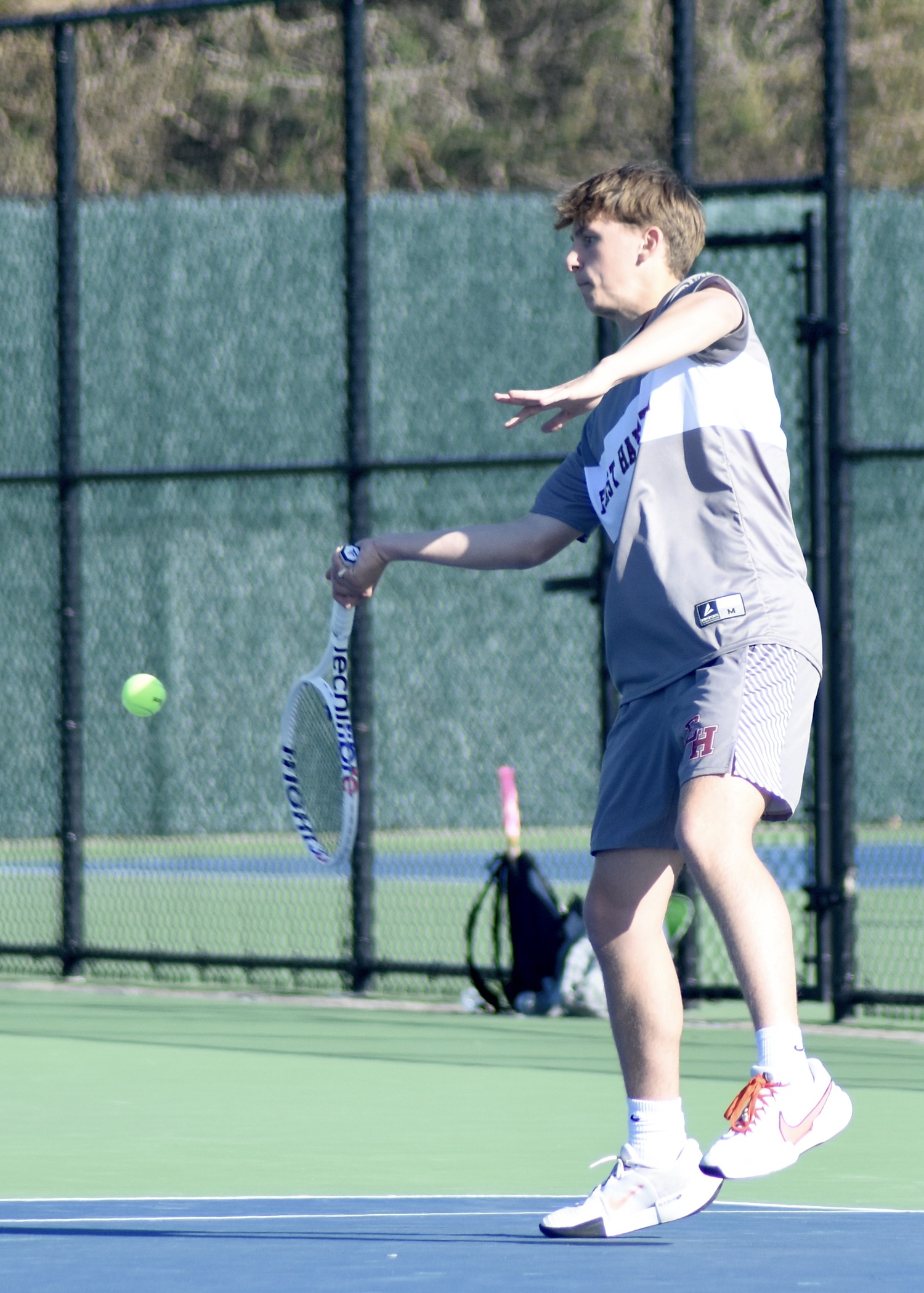 Senior C.J. Baumrind returns a serve. DESIRÉE KEEGAN