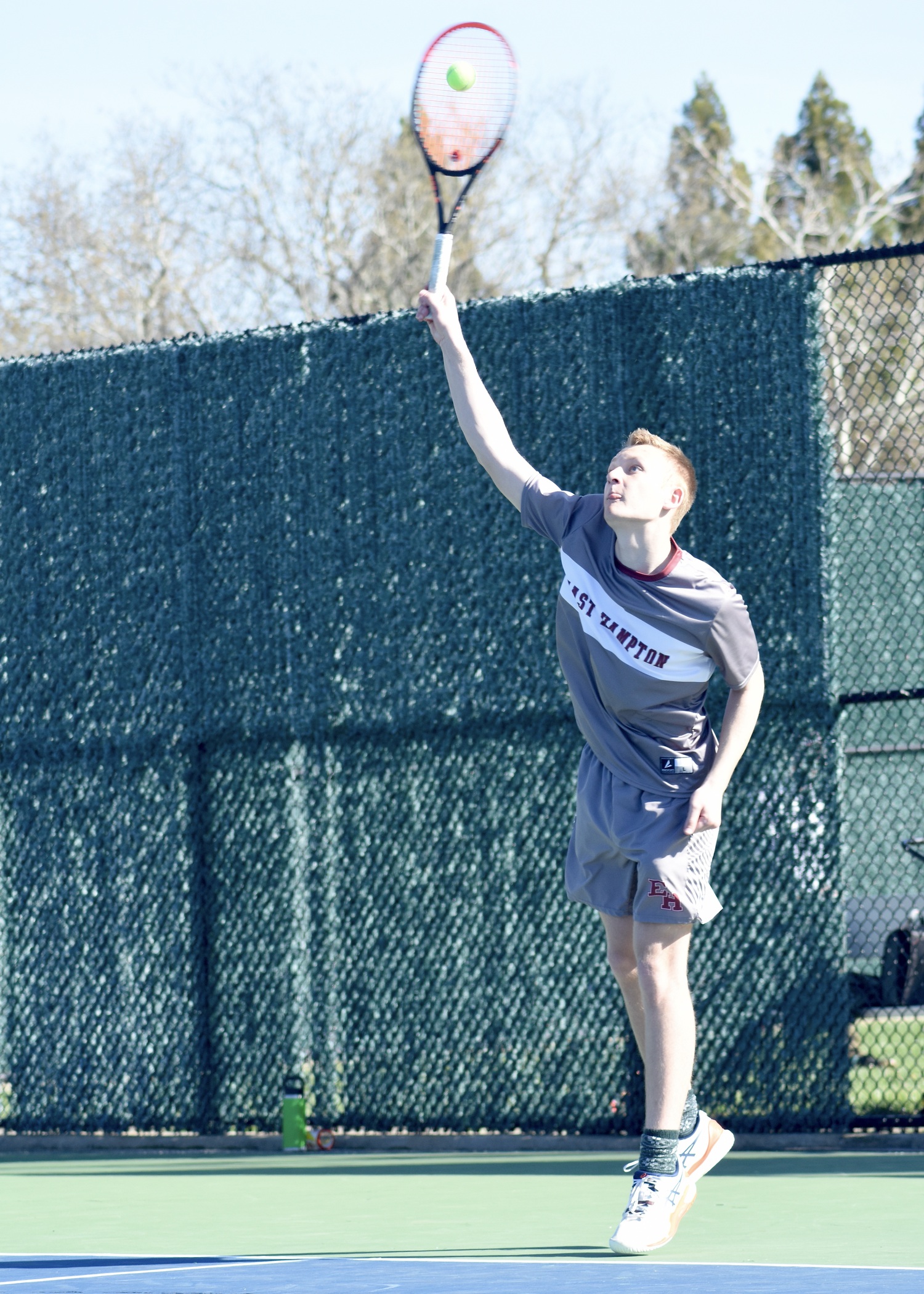 Senior Kiefer Mitchell serves. DESIRÉE KEEGAN
