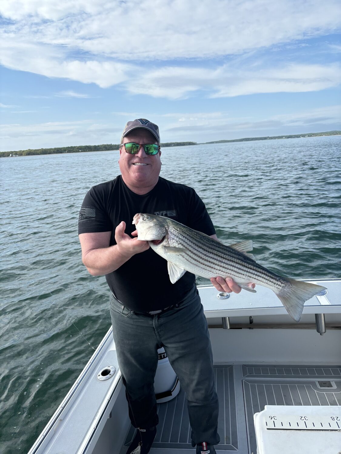 John Hubbel with a Peconic Bay slot striped bass. BILL PELL
