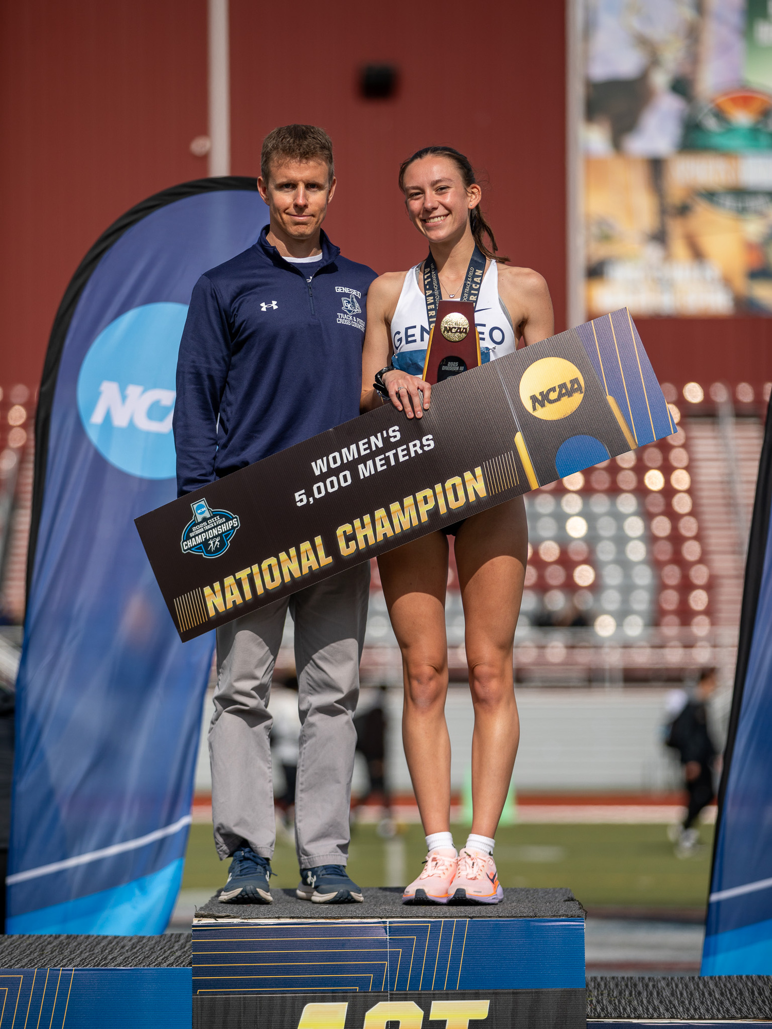 Penelope Greene atop the podium with assistant coach Dan Moore.  CORIE HOLDING