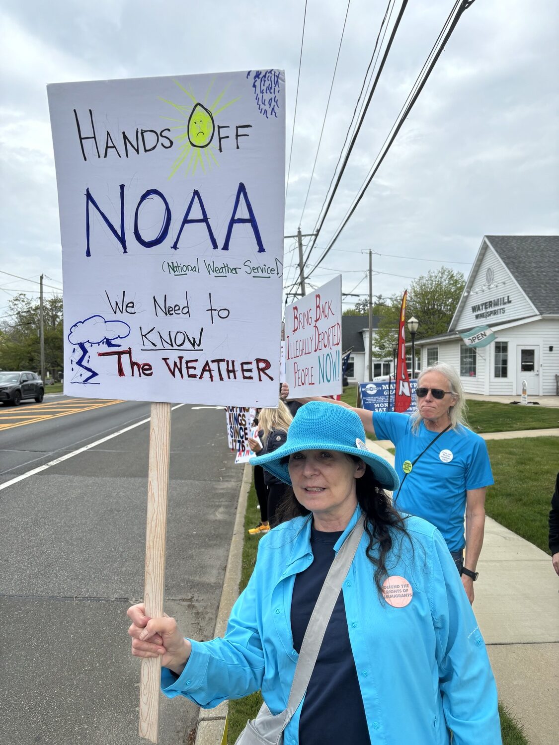 Mary Anne Mulvihill-Decker joins a protest in Water Mill to get the word about defunding NOAA. With hurricanes becoming stronger, more frequent,and more unpredictable, our ability to predict them should be getting more accurate, not less so. JENNY NOBLE