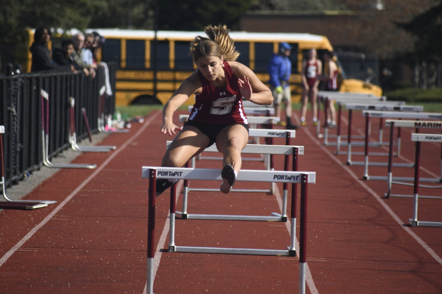 A Southampton student-athlete competes in the 100-meter hurdles.  DREW BUDD