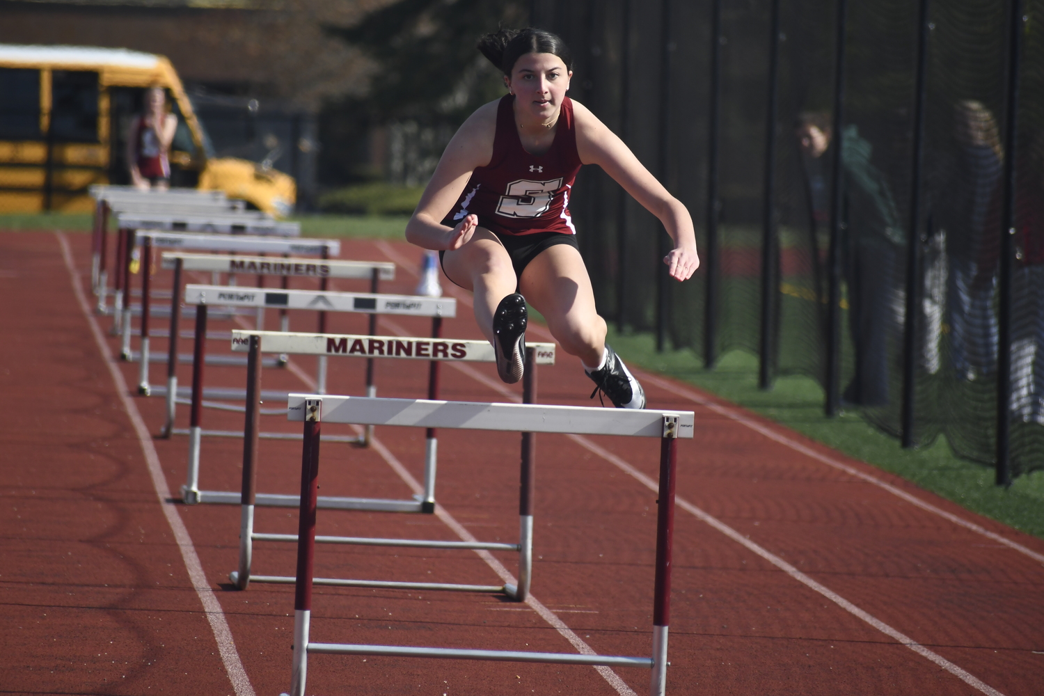 A Southampton student-athlete competes in the 100-meter hurdles.  DREW BUDD