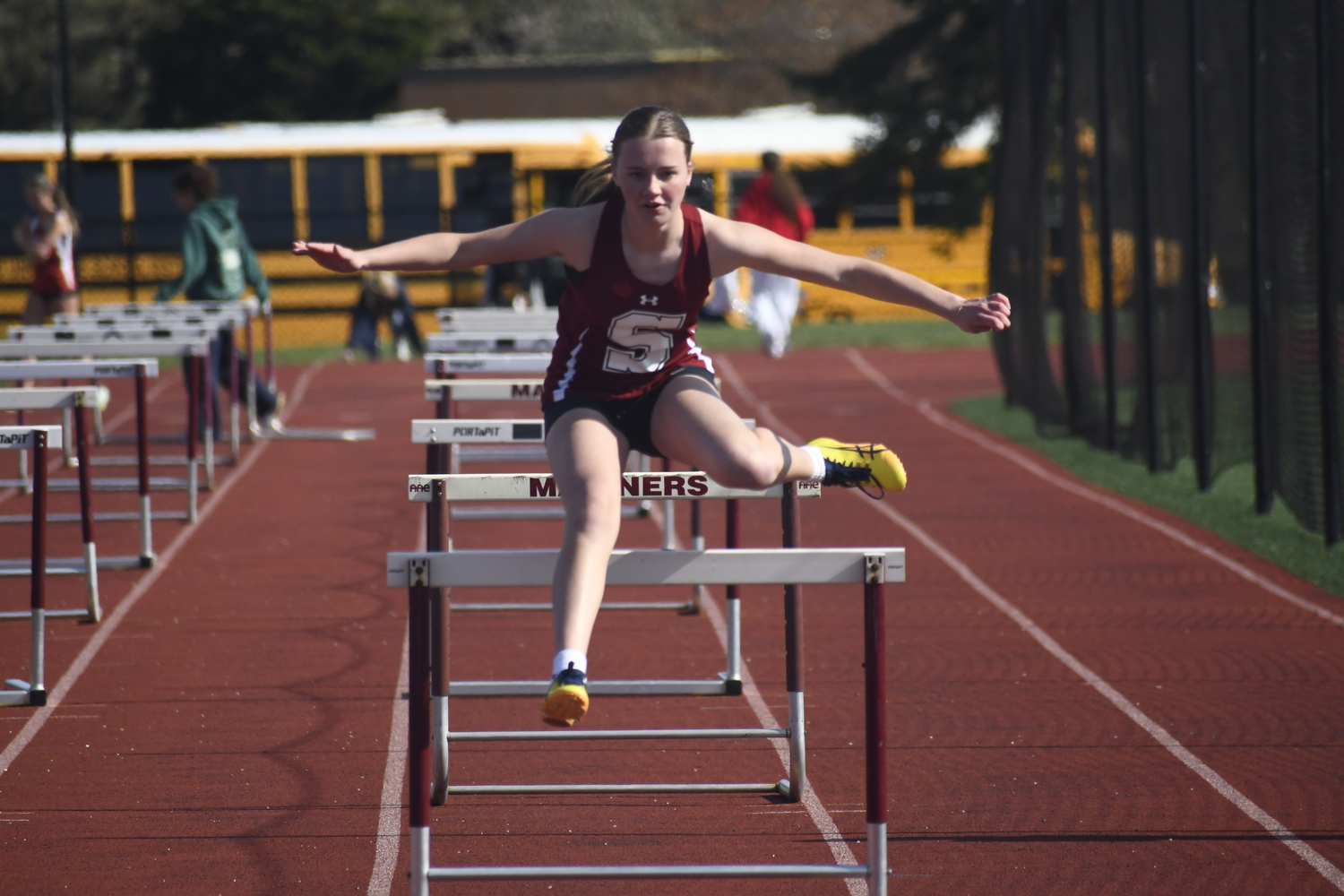A Southampton student-athlete competes in the 100-meter hurdles.  DREW BUDD