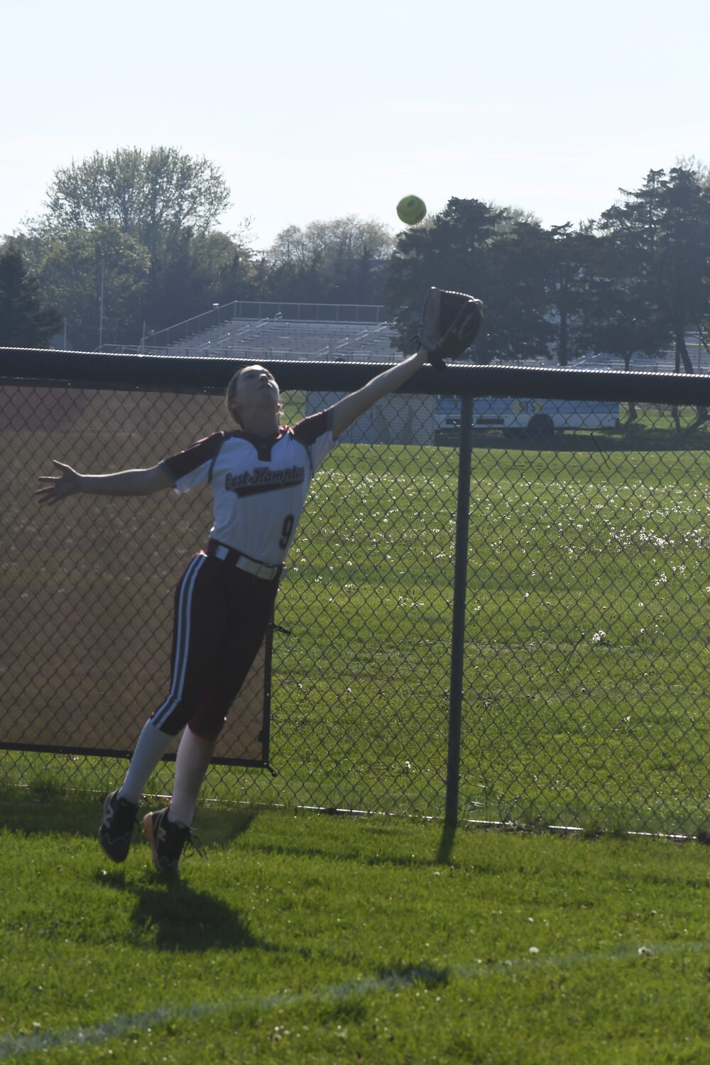 Hailey Rigby makes a catch in the right field corner.  DREW BUDD