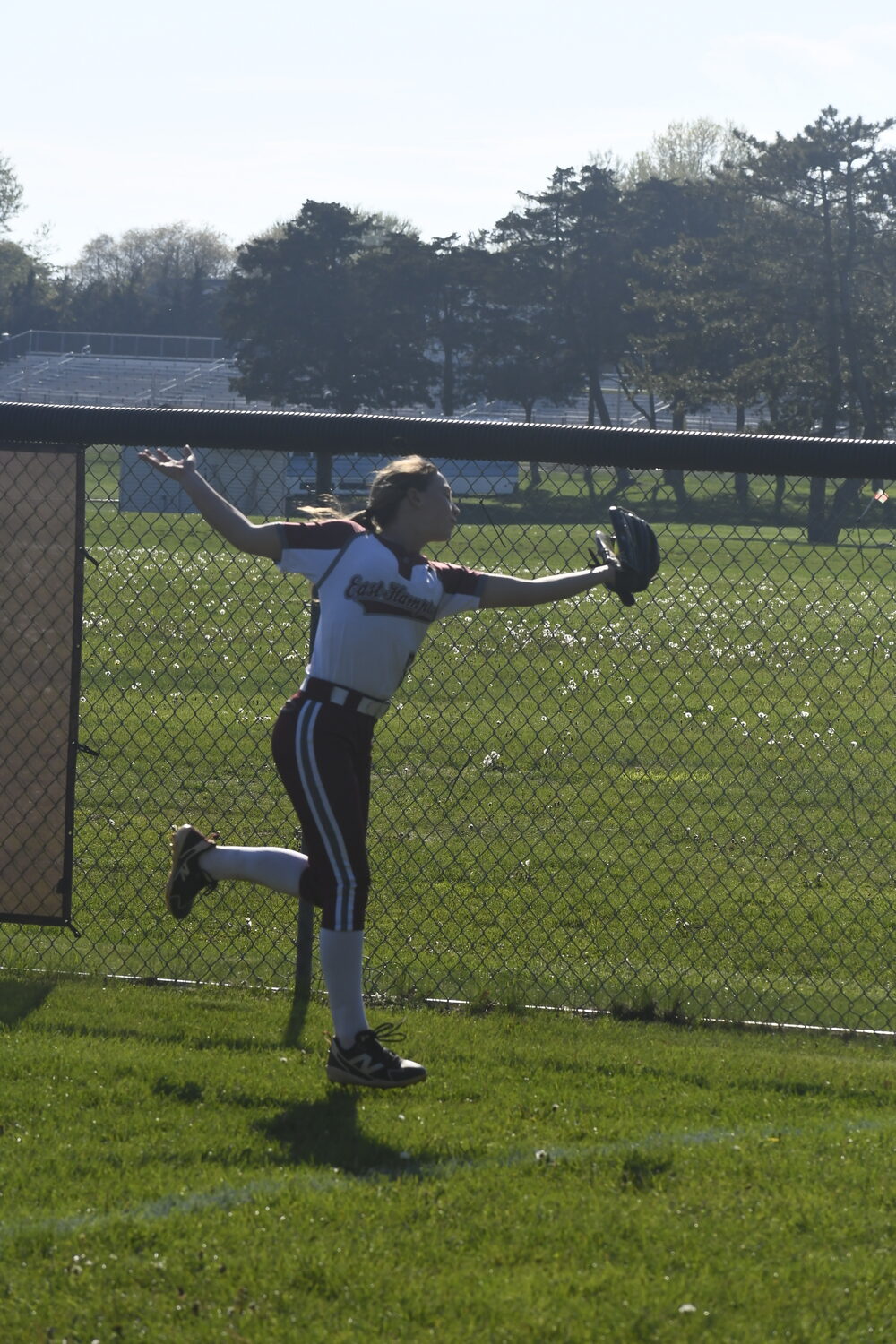 Hailey Rigby makes a catch in the right field corner.  DREW BUDD