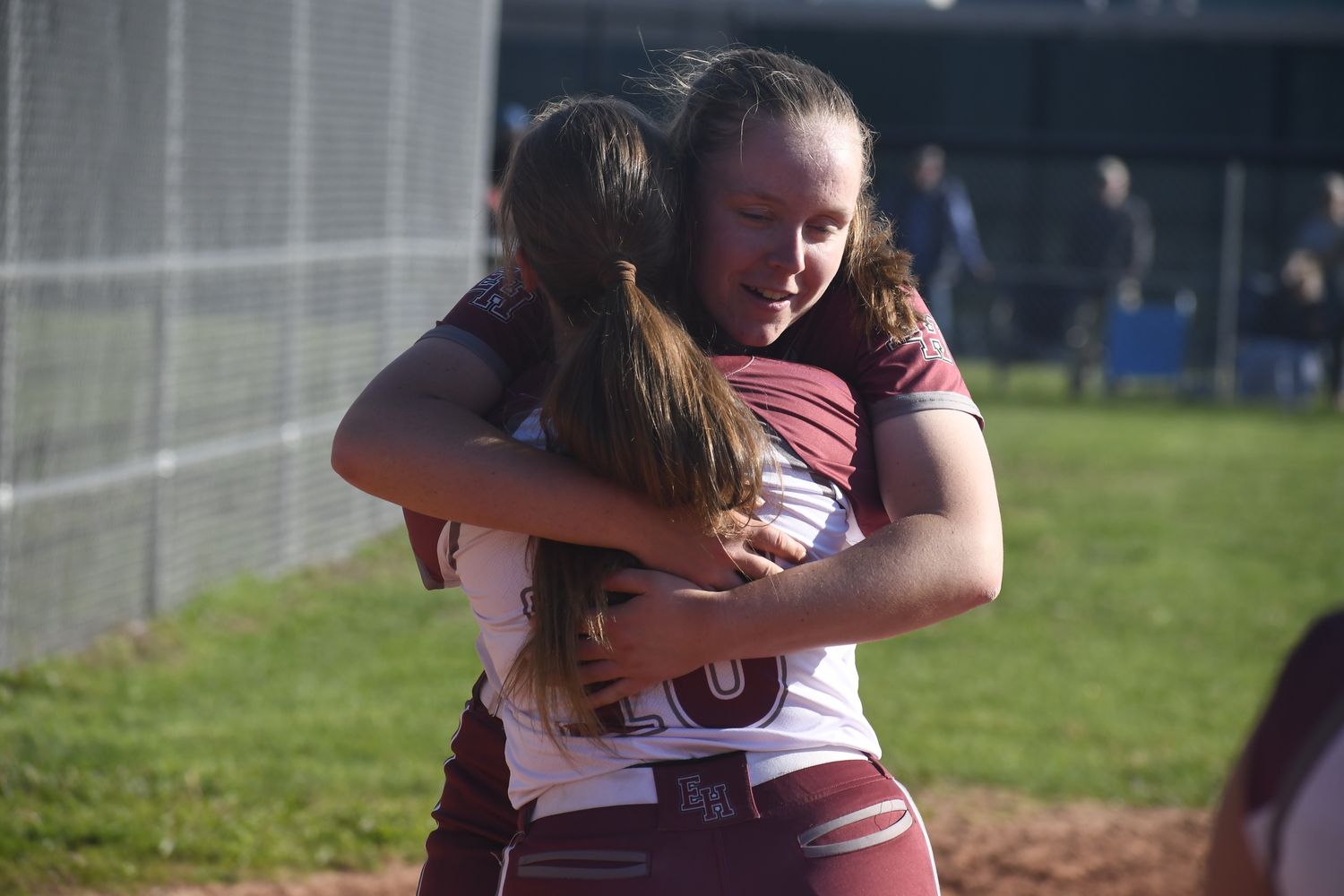 Bonac seniors Susie DiSunno and Mackenzie Lenahan hug one another just before being honored by their softball team after a victory over Hauppauge on Thursday, May 8.   DREW BUDD