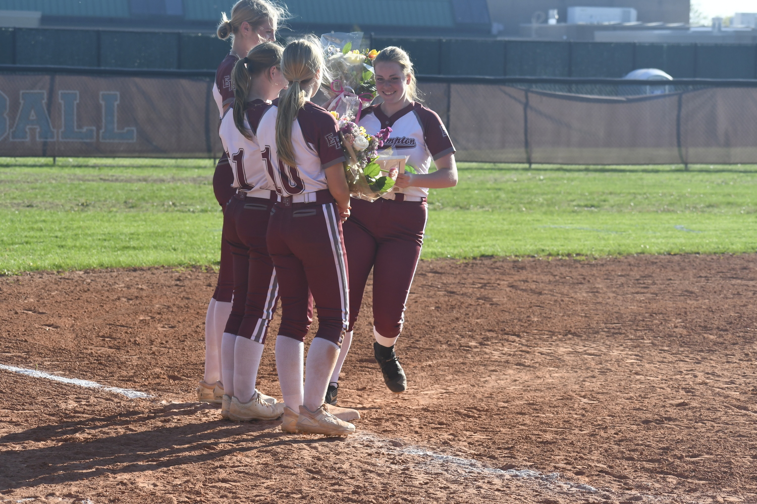 Mackenzie Lenahan takes her trip around the bases where at each base teammates gave her something.  DREW BUDD