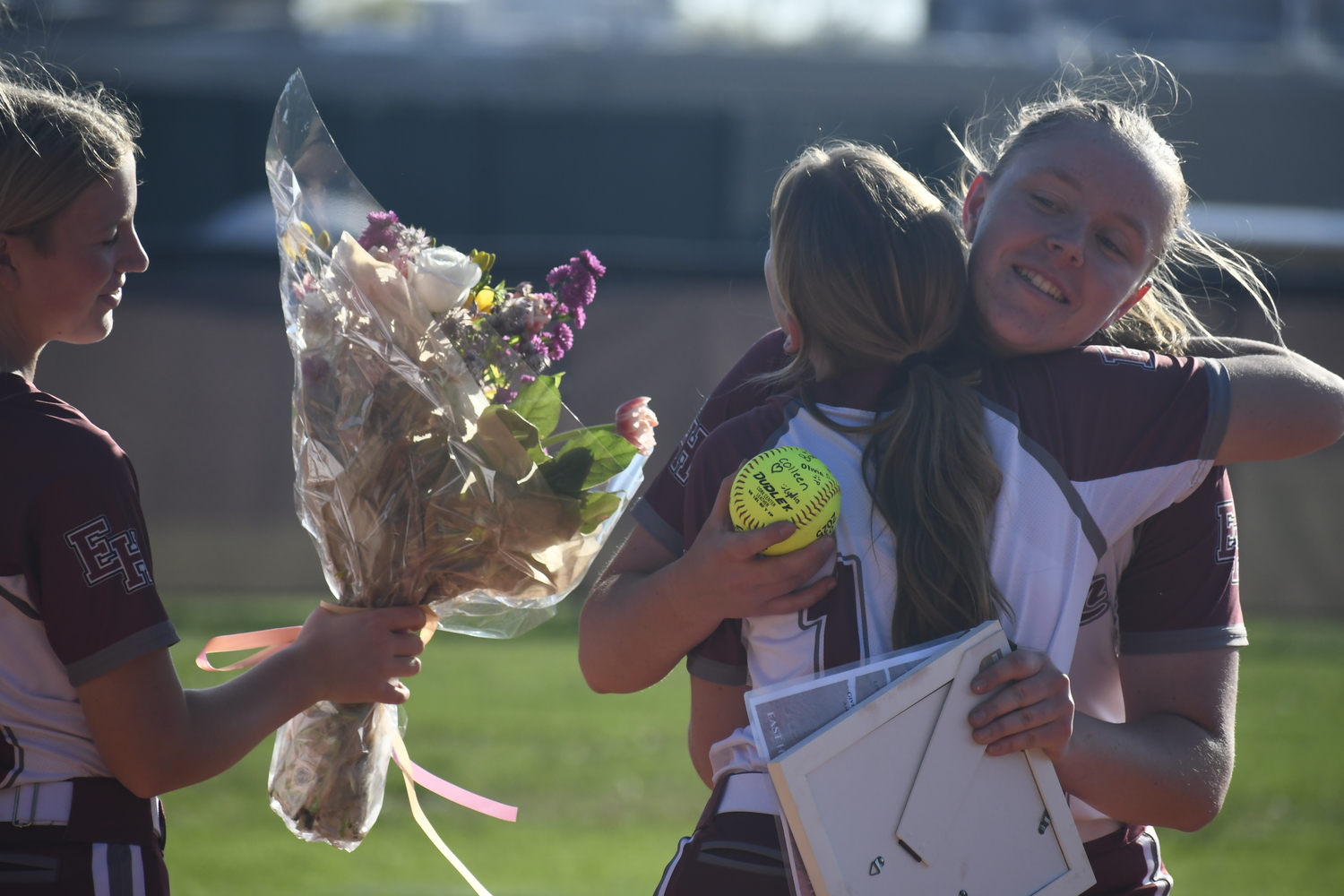 Susie DiSunno gets a hug from teammates at third base.   DREW BUDD