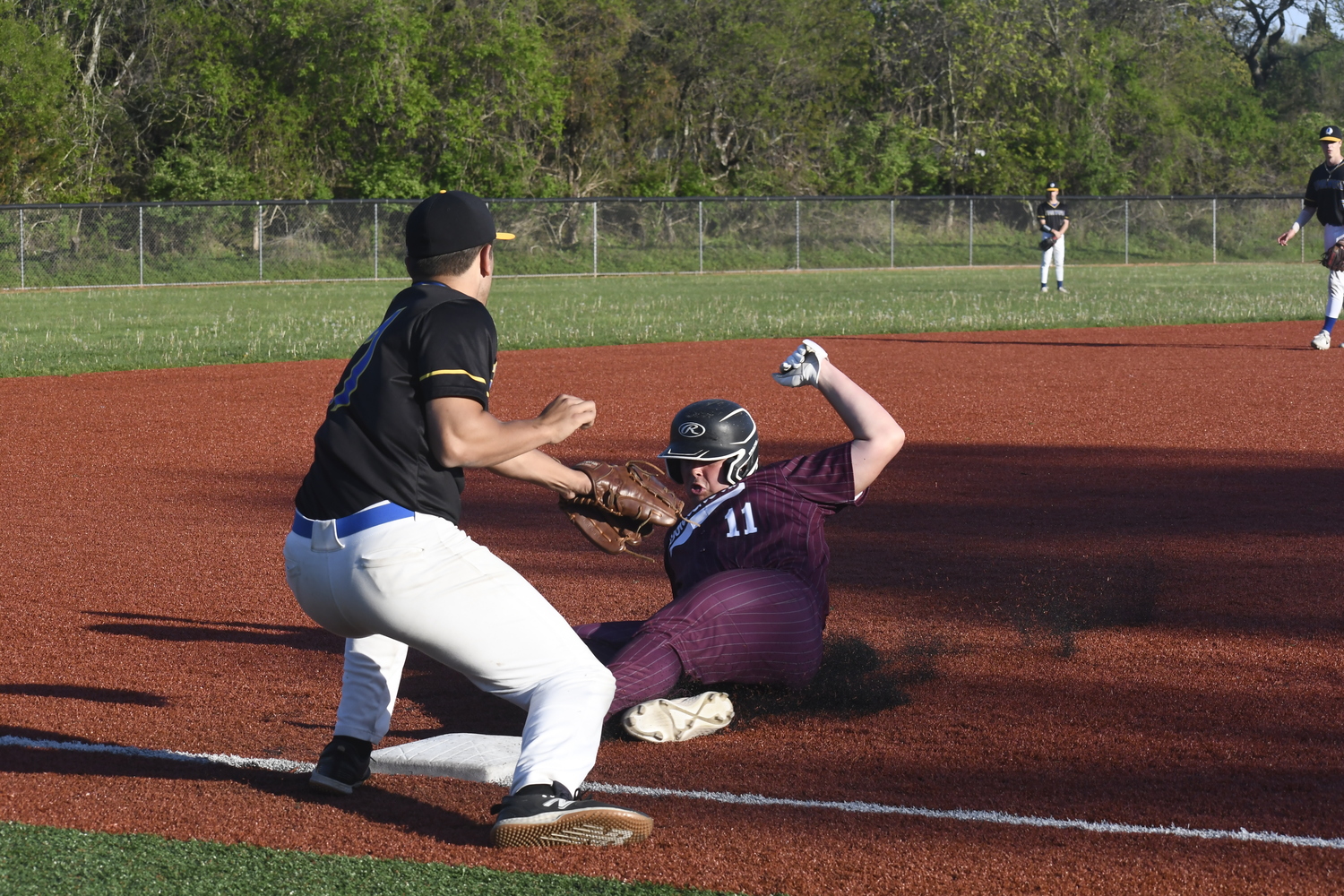 Trevor Meehan slides safely into third base.   DREW BUDD