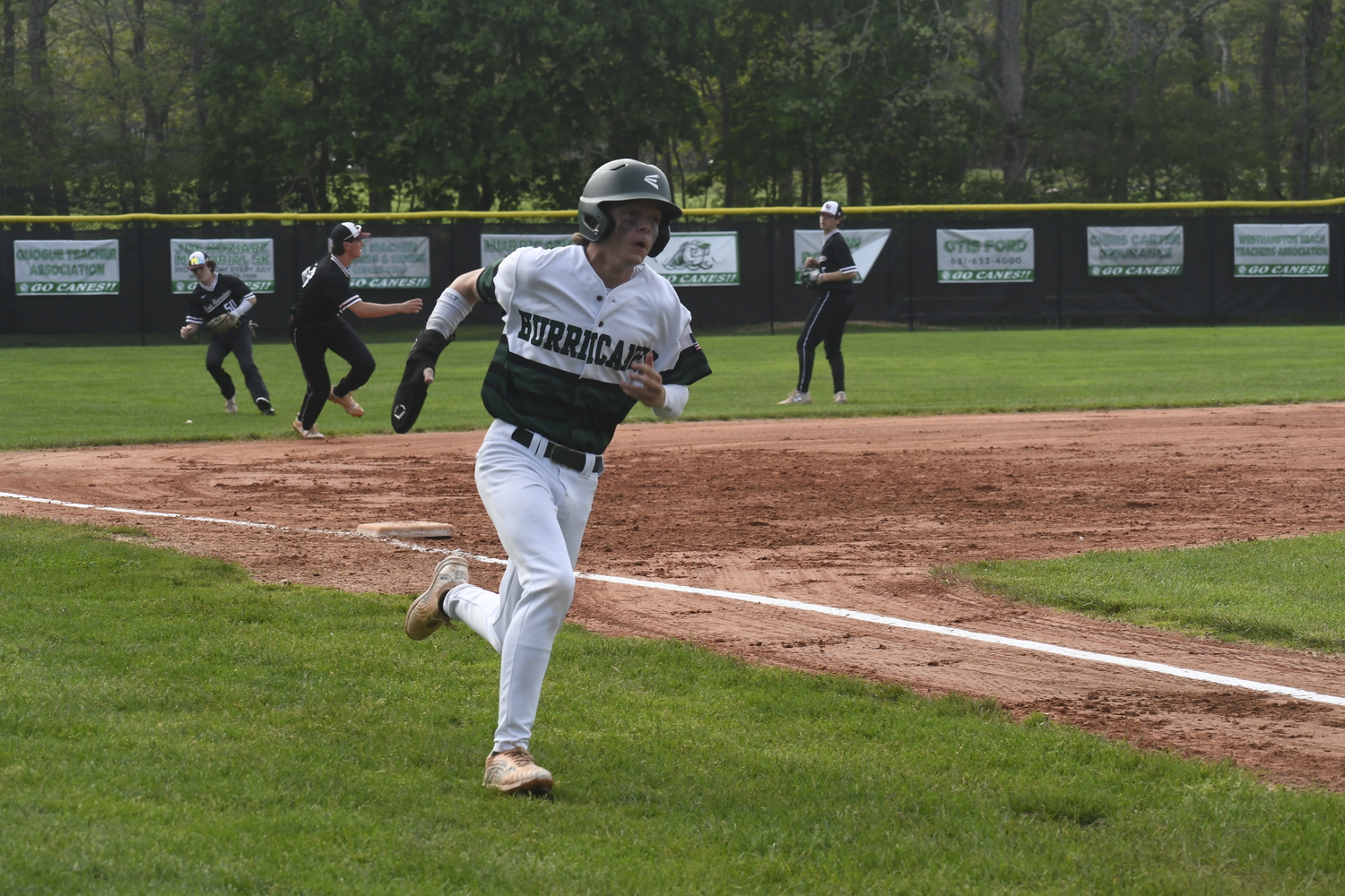 Ethan Seltzer heads home and scores after an error at third base.  DREW BUDD