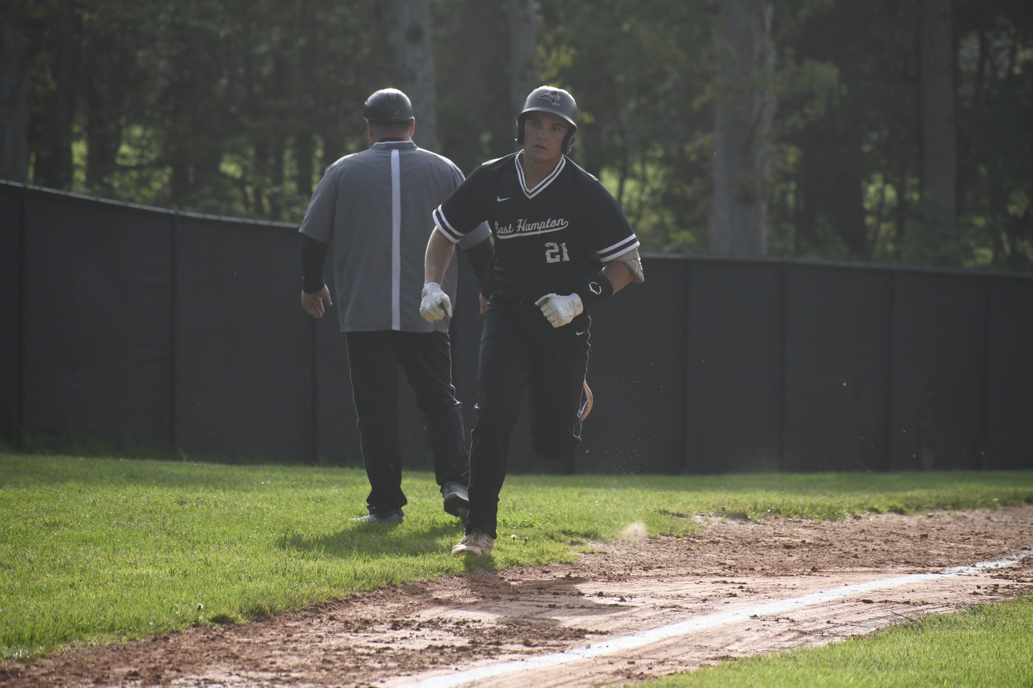 Carter Dickinson rounds third base and heads home after hitting a home run.  DREW BUDD