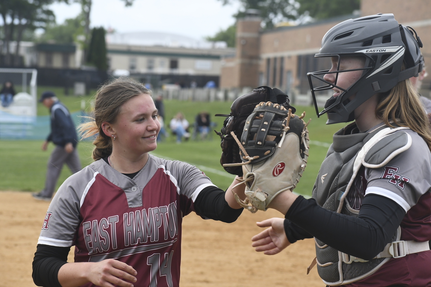Isabel Briand gets a high-five from her catcher Susie DiSunno after striking out a Rocky Point batter to end an inning.   DREW BUDD