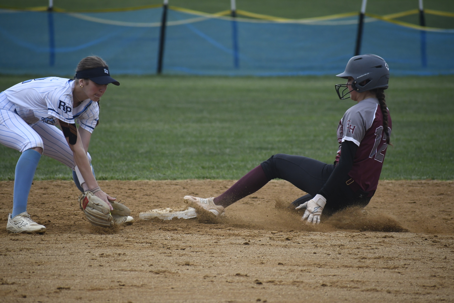 East Hampton's Alexa Schaffer slides well ahead of the throw at second base for a stolen base.  DREW BUDD
