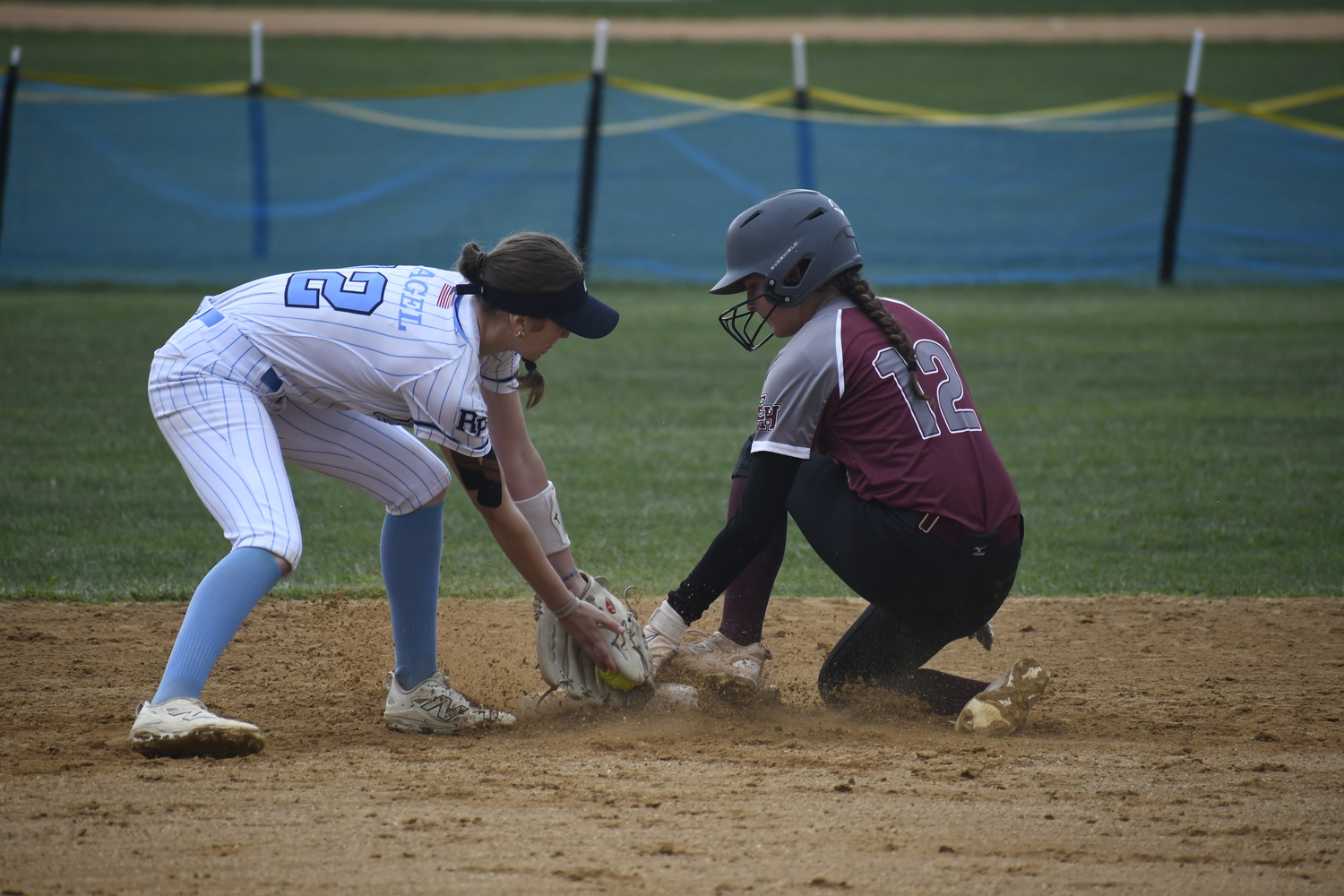 East Hampton's Alexa Schaffer slides well ahead of the throw at second base for a stolen base.  DREW BUDD