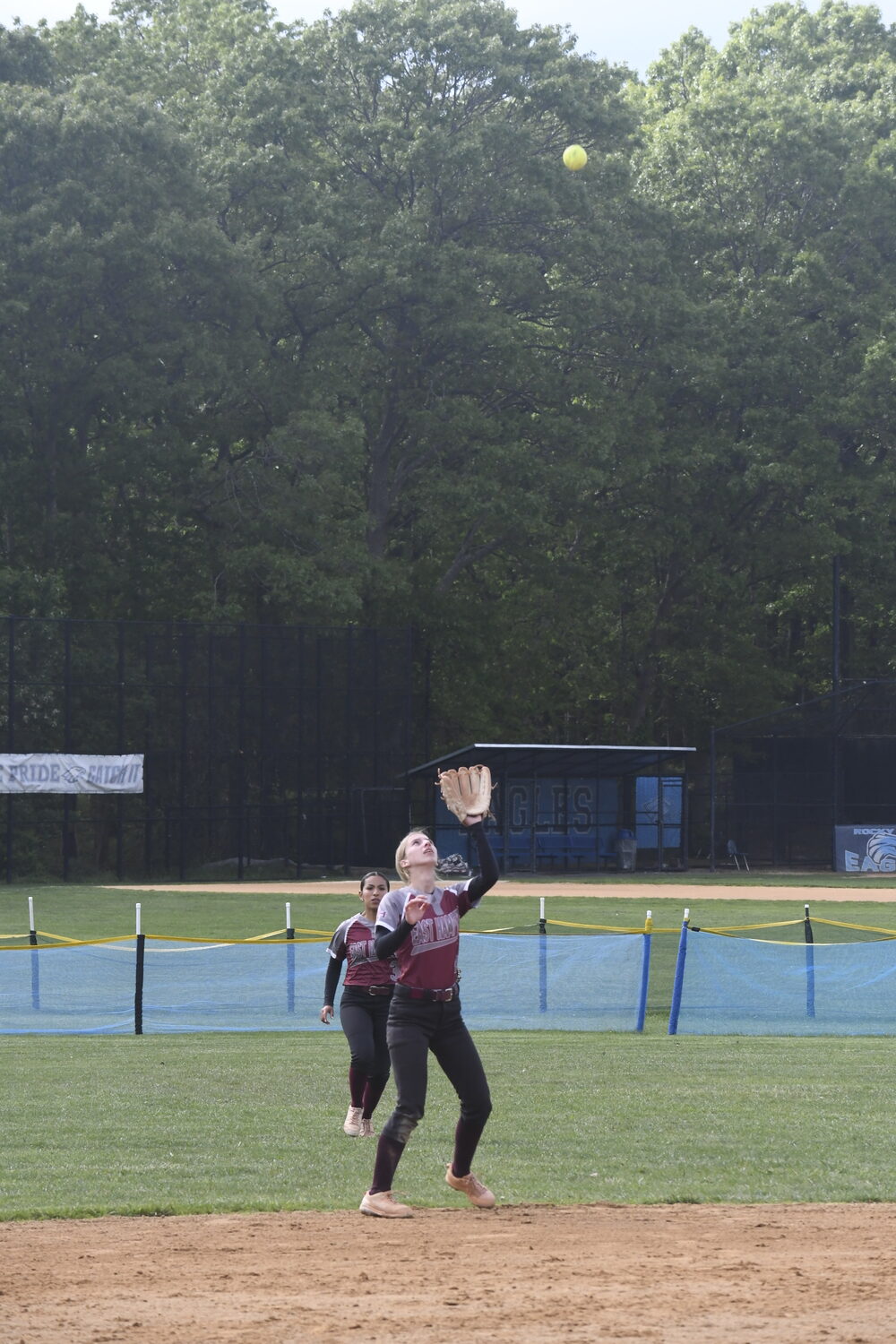 East Hampton shortstop Ella Abran lines up a pop fly and eventually makes the catch for an out.  DREW BUDD