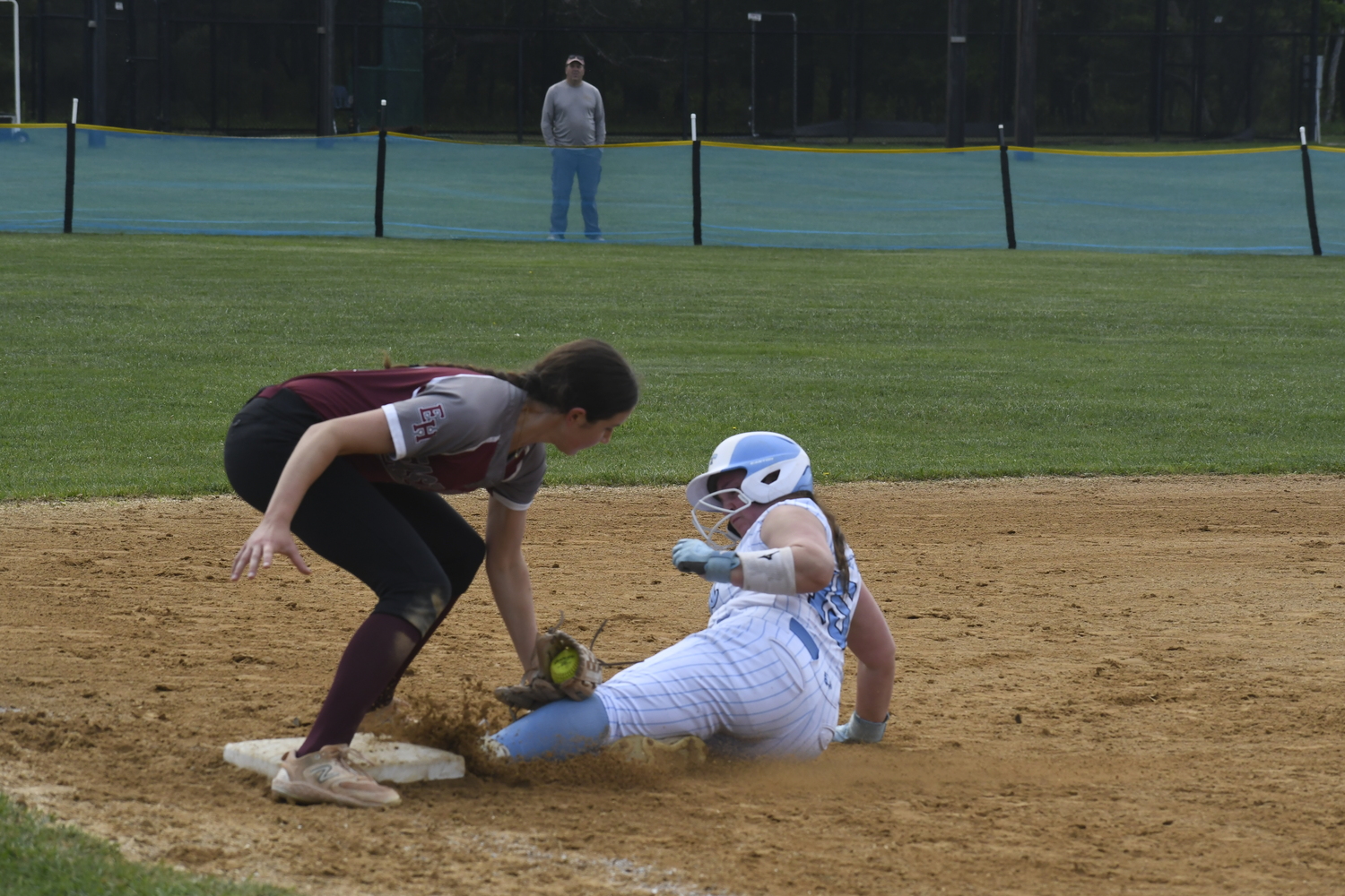 Bonac third baseman Alexa Schaffer applies a tag to a Rocky Point base runner trying to reach third for an out.   DREW BUDD