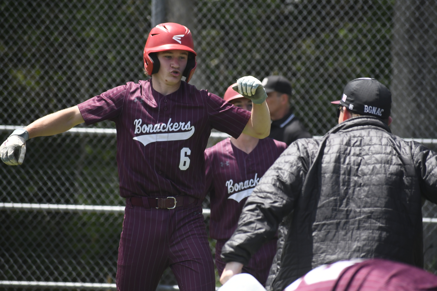 Livs Kuplins is fired up after scoring one of his team's 13 runs, all with two outs, in the fourth inning of Saturday's 15-4 win over Rocky Point.  DREW BUDD