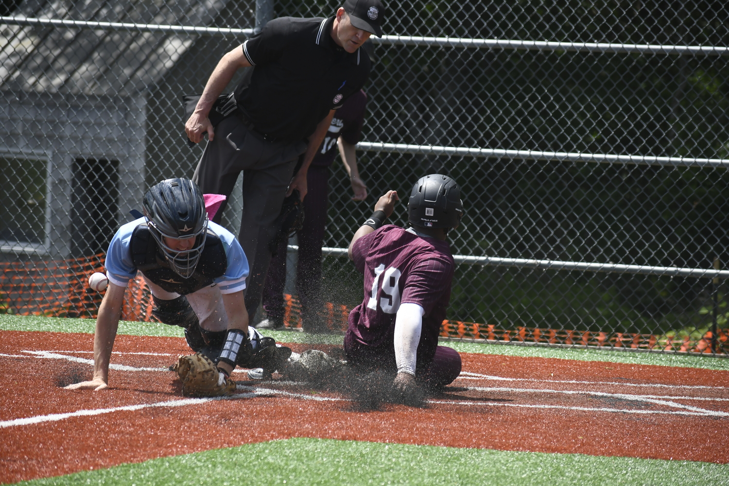 Victoreddy Aguero slides home safely ahead of a throw to home on Saturday.   DREW BUDD