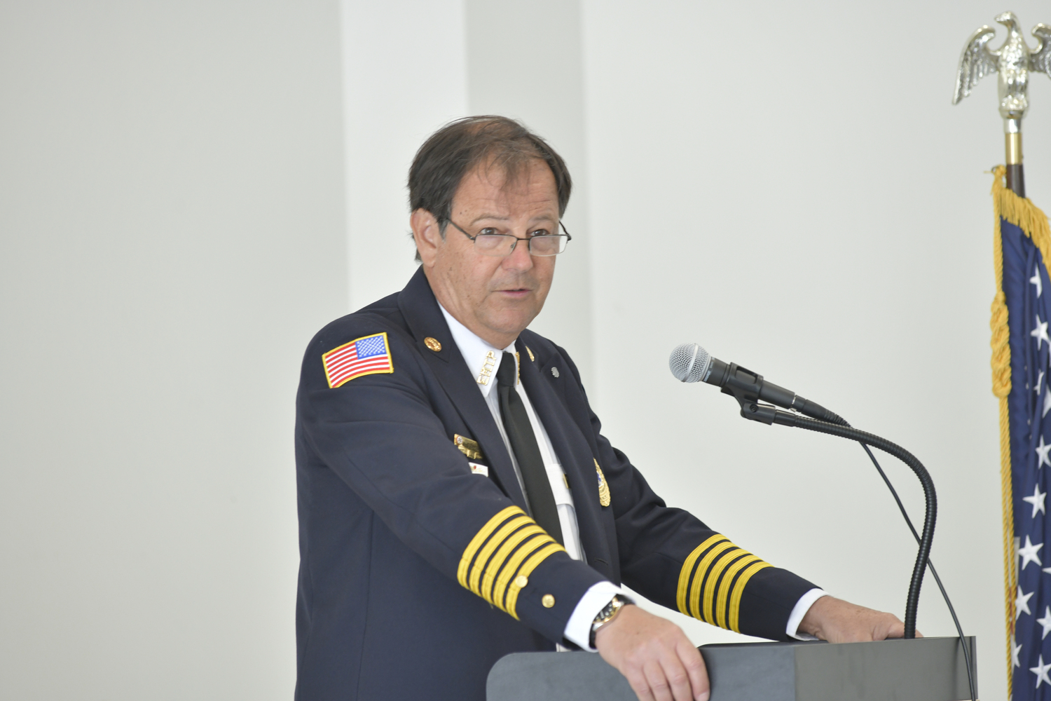 Philip Cammann welcomes the crowd to the Southampton Volunteer Ambulance, Inc. building dedication on Sunday.  DANA SHAW