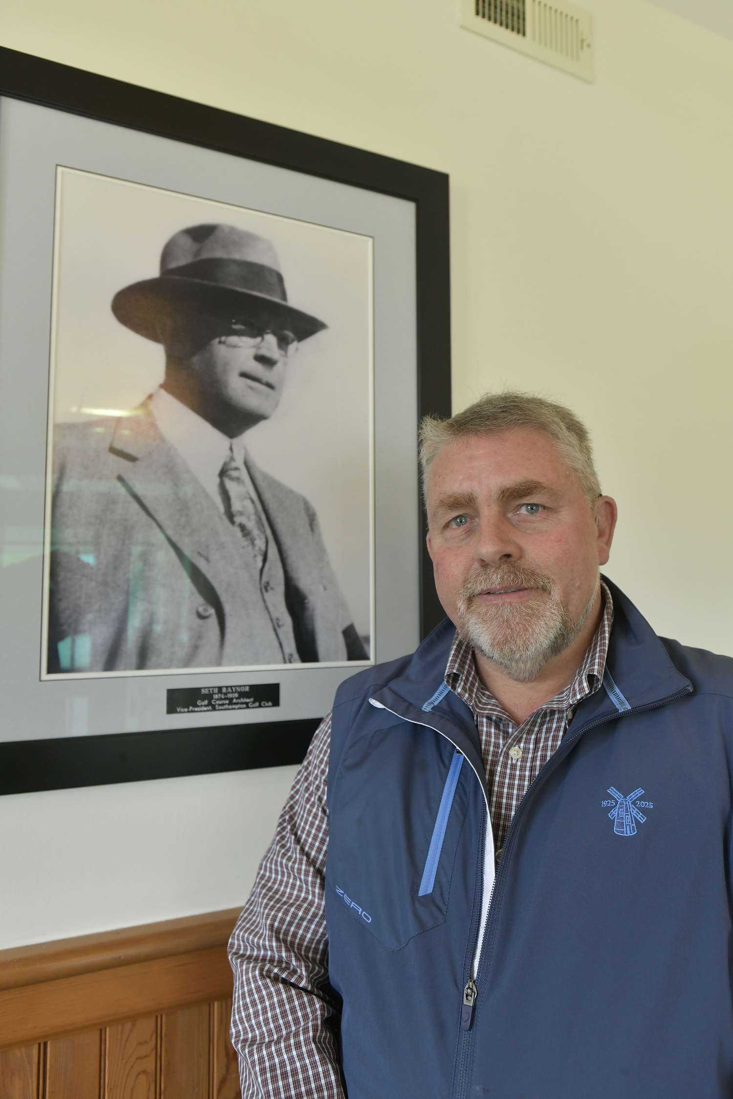 Southampton Golf General Manager Craig Ruhling with a portrait of course designer Seth Raynor.  DANA SHAW