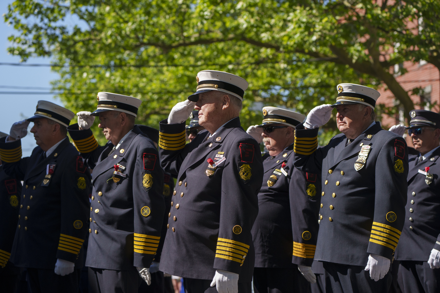Members of the Sag Harbor Fire Department salute at a wreath-laying ceremony during the village's Memorial Day parade. LORI HAWKINS PHOTOS