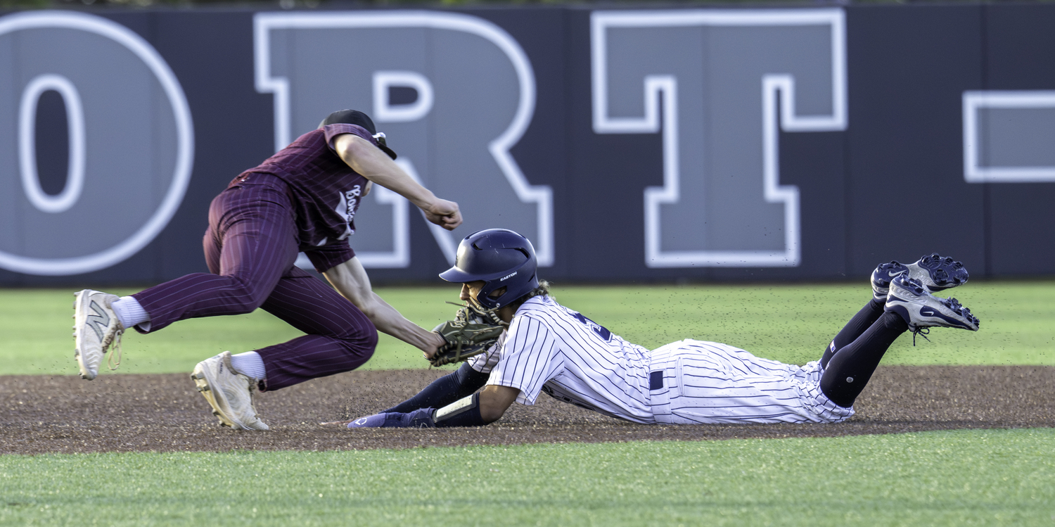 East Hampton second baseman Livs Kuplins tags out an ESM base runner trying to steal second base.   MARIANNE BARNETT