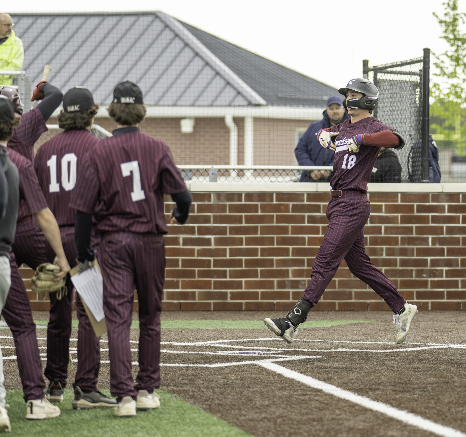 Mason Miles is greeted at home plate after his first inning home run at ESM on Friday.  MARIANNE BARNETT