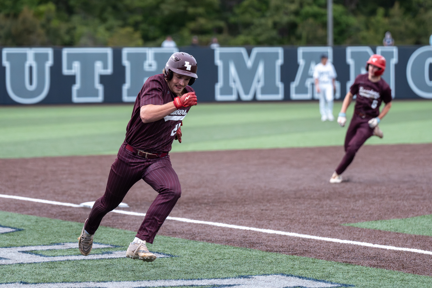 Hudson Beckman, with Hudson Meyer right behind, heads toward home plate in the Bonacker's six-run ninth inning.   RON ESPOSITO